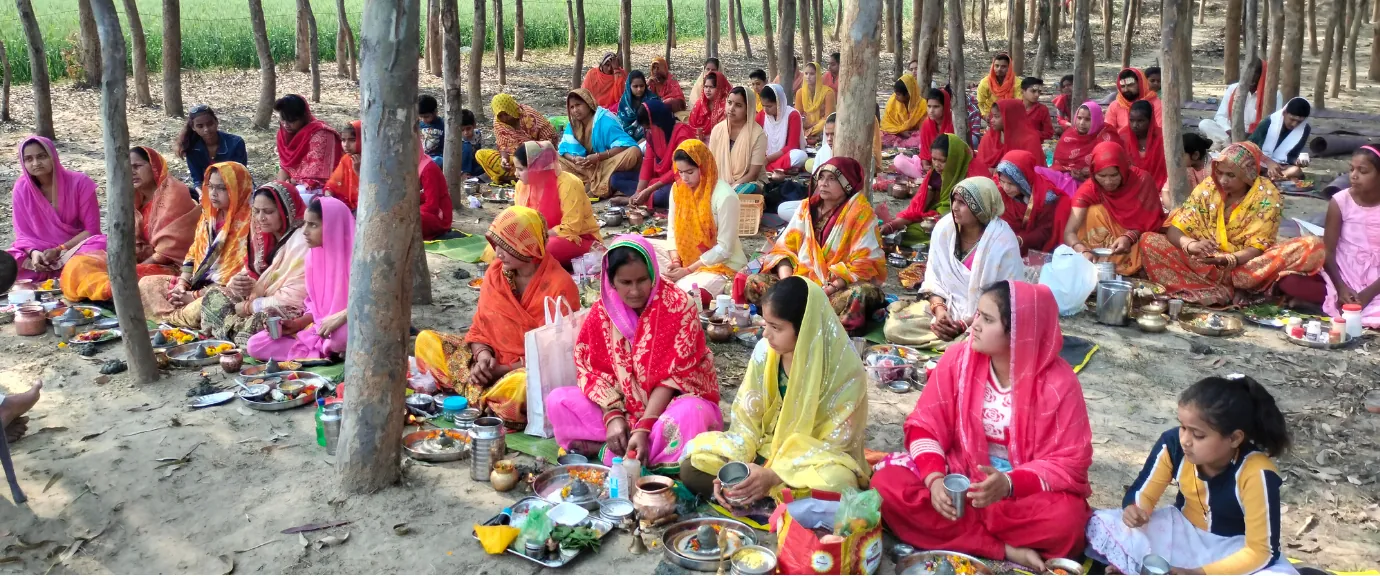Women gathered in a wooded area for a communal religious ceremony