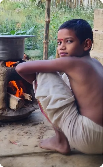 Student tending a wood-fired stove